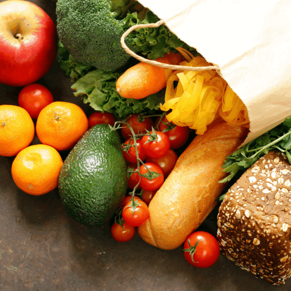 Photo is of a shopping bag with fresh food coming out of it.